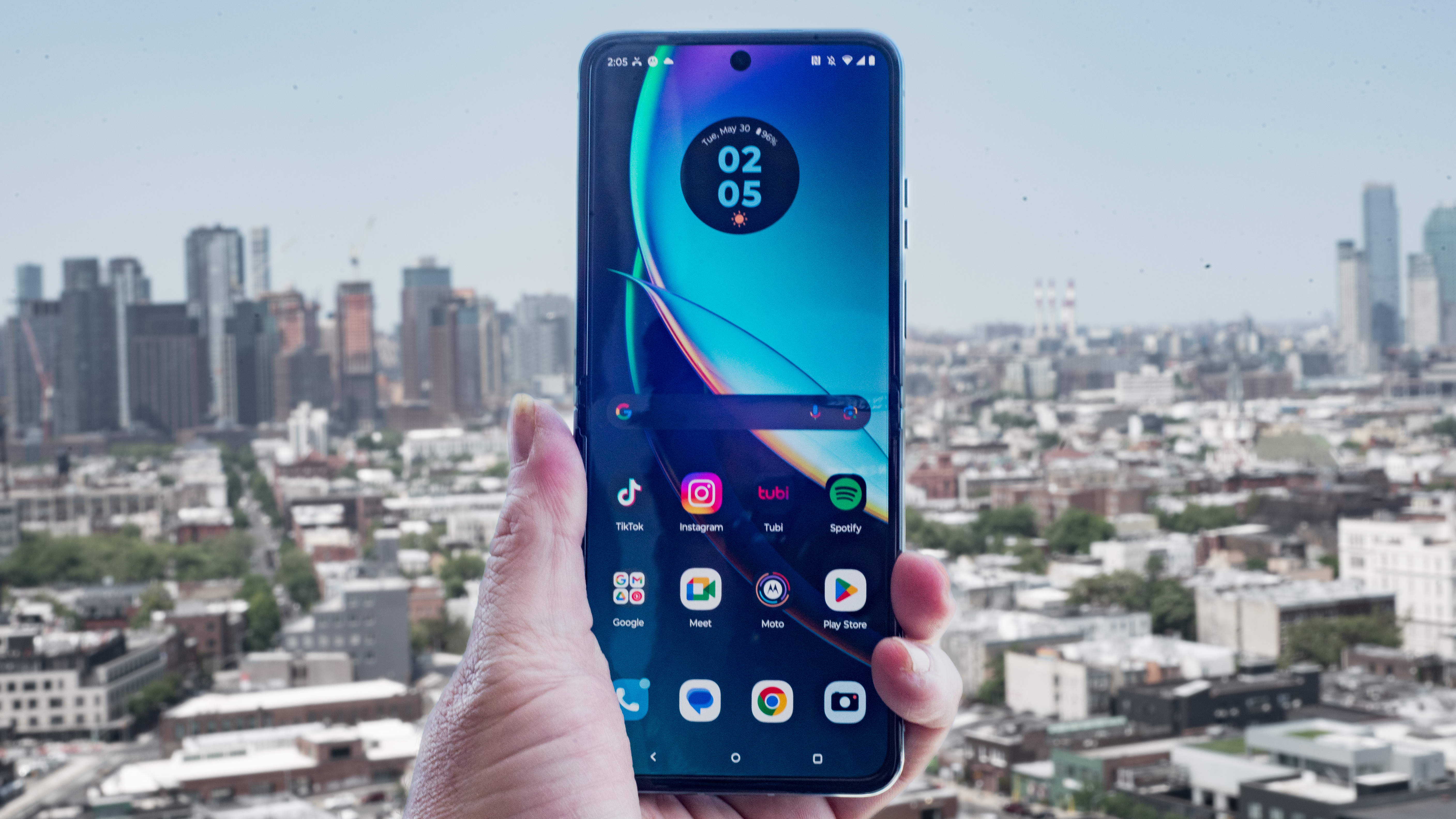 Motorola Razr Plus 2023 open with home screen and New York City skyline behind