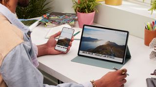 Samsung Galaxy Tab S7 FE and Samsung phone being used together
