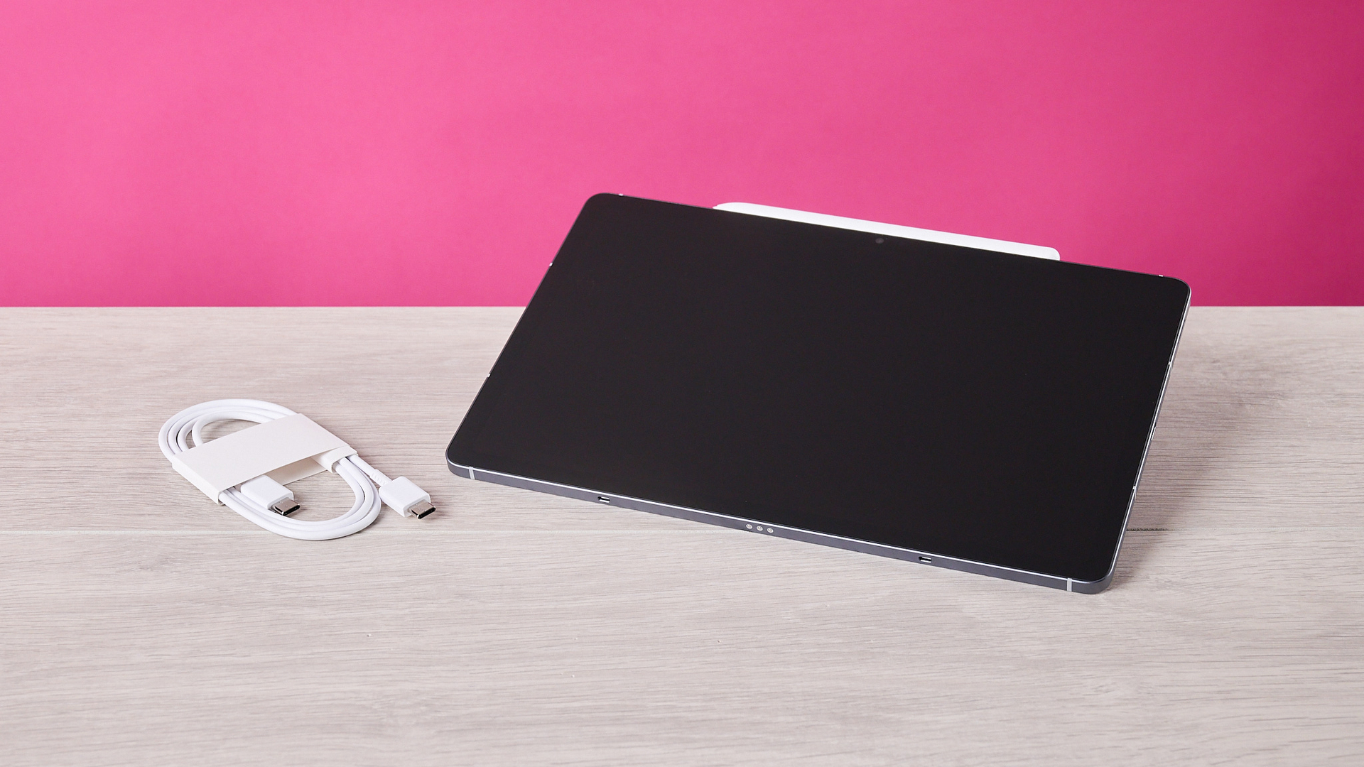 The Samsung Galaxy Tab S10 FE alongside its coiled up USB-C cable.