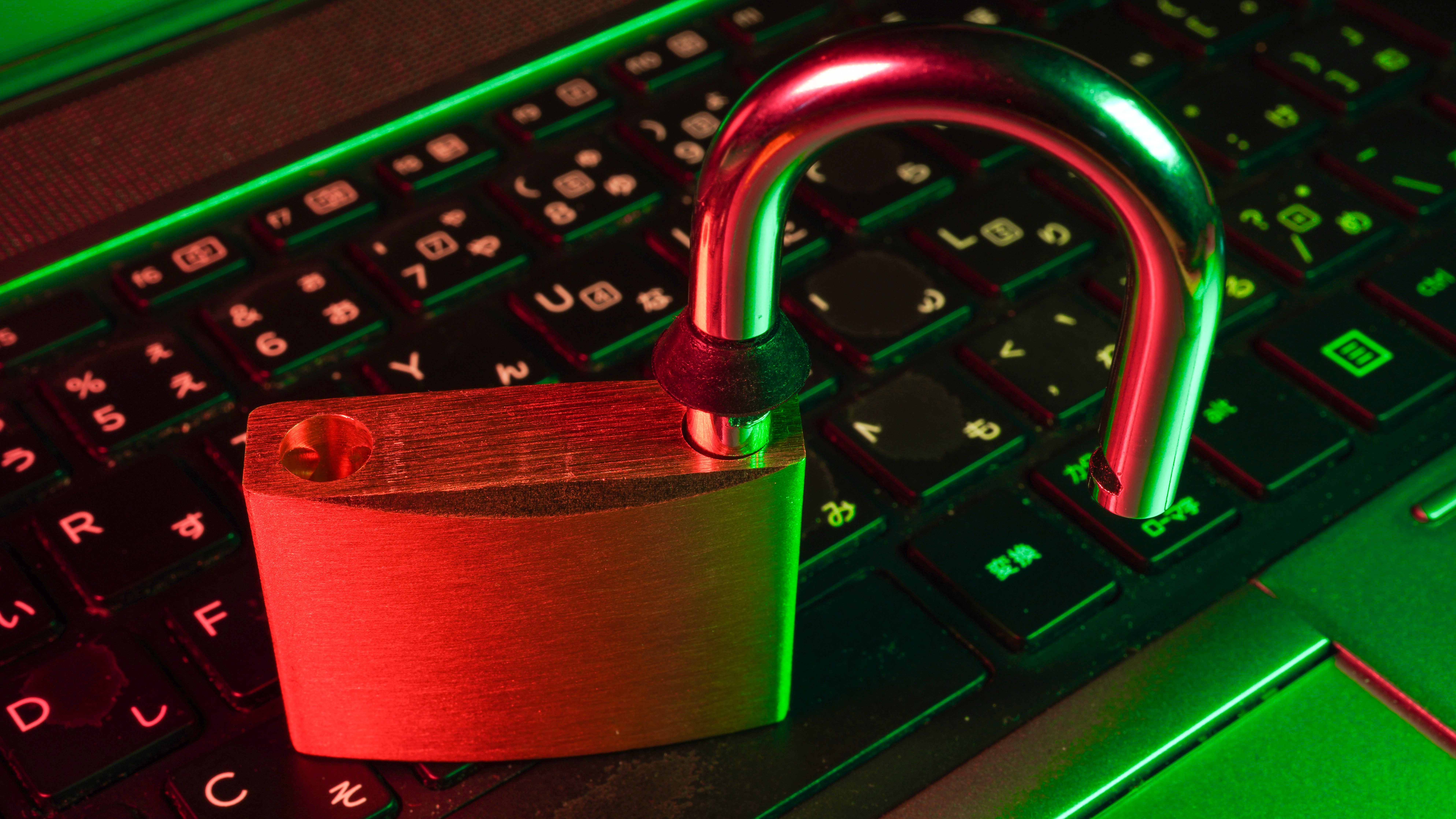 Unlocked padlock on a computer keyboard