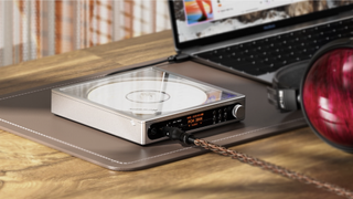 FiiO DM15 with Fiio FT13 headphones plugged in, on a wooden table