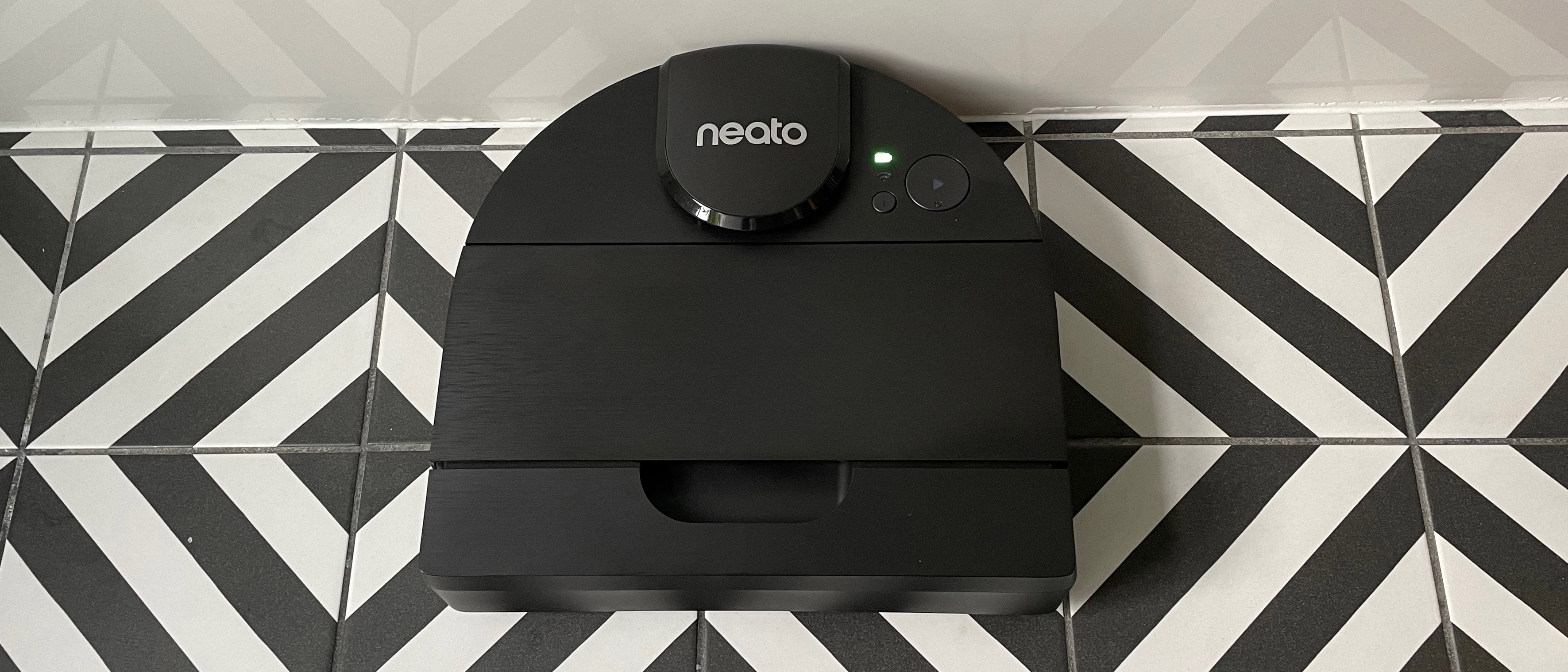 The Neato D9 on a black and white striped hard floor