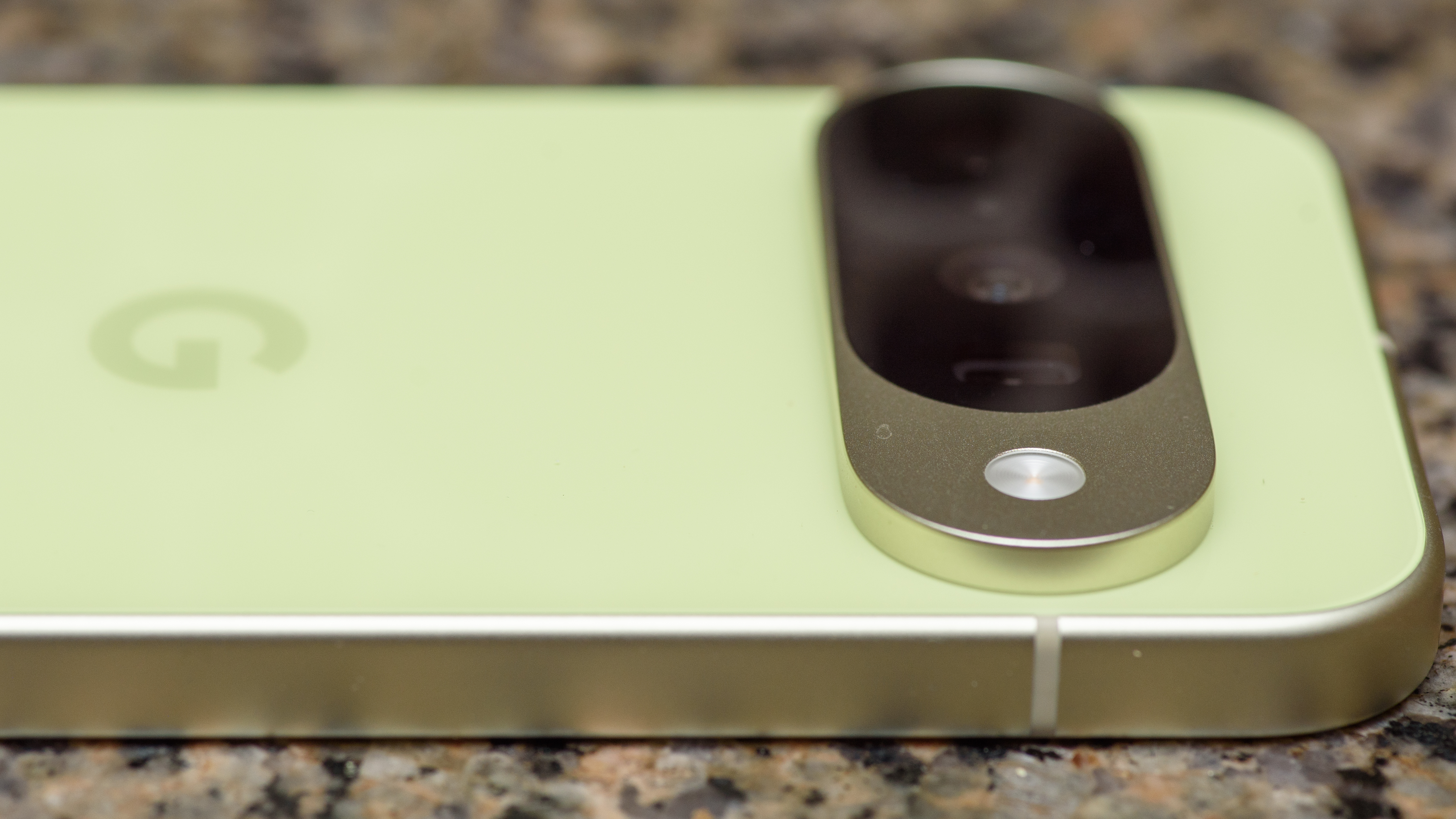 Google Pixel 10 in Lemongrass against a bubbly backsplash