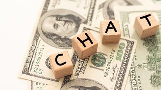 Chat written on wooden blocks and money.