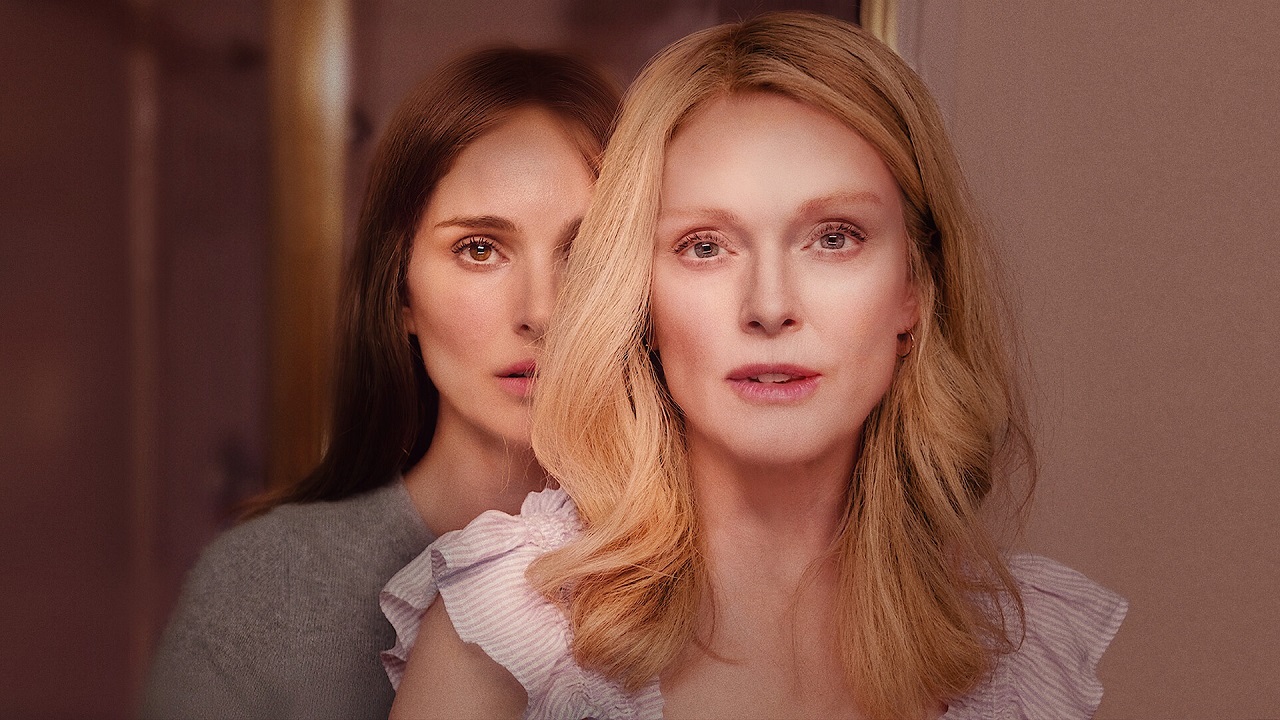 Natalie Portman standing behind Julianne Moore in a promotional image from Oscar-nominated movie May December