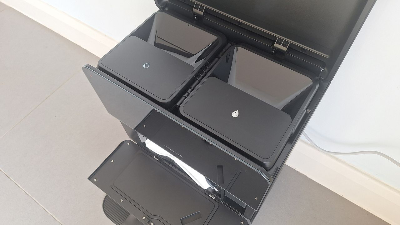 Roborock Saros 10 dock with top open to show clean and dirty water tanks