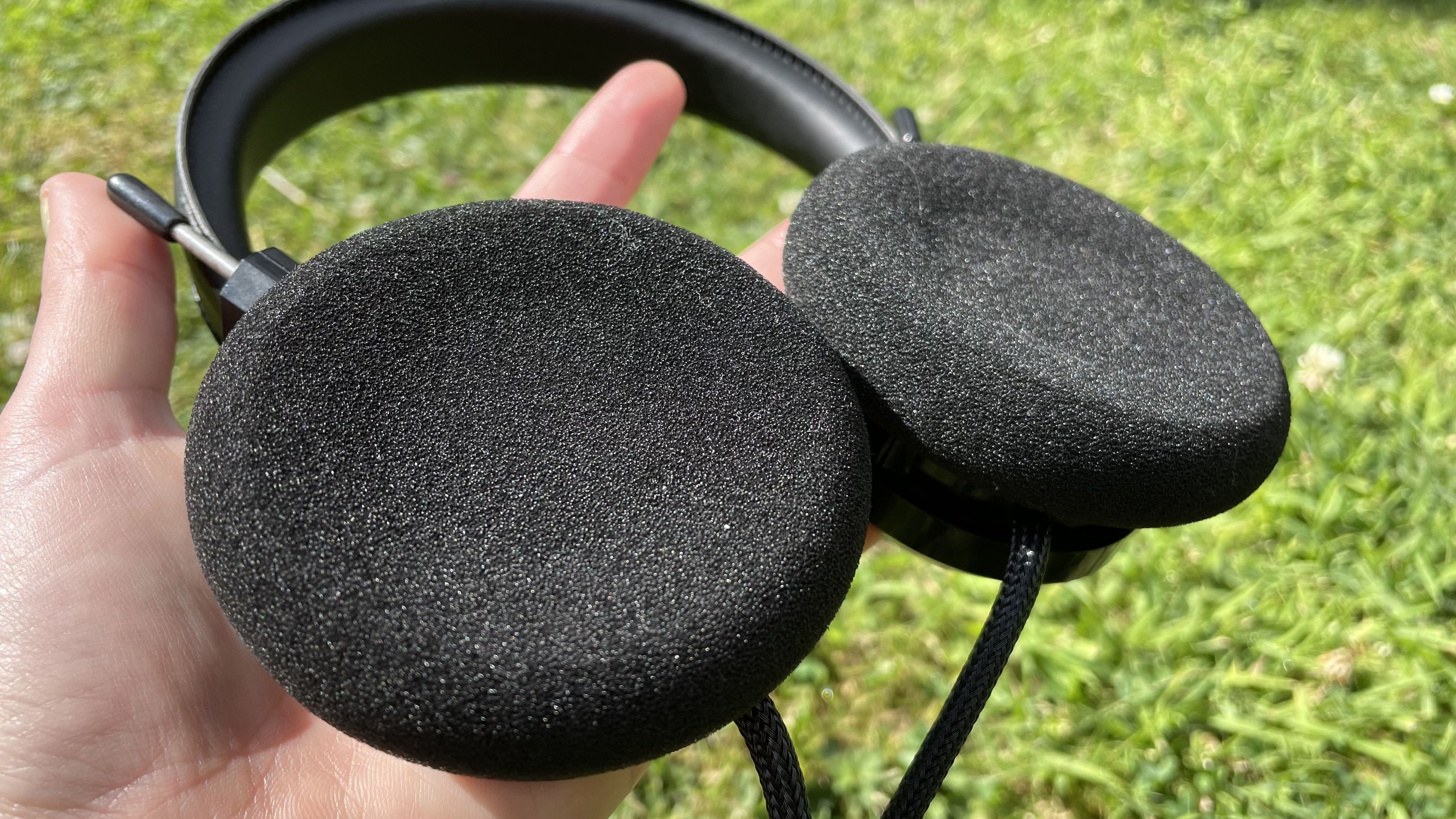 Becca holding the Grado SR80x headphones so you can see the foam interior.