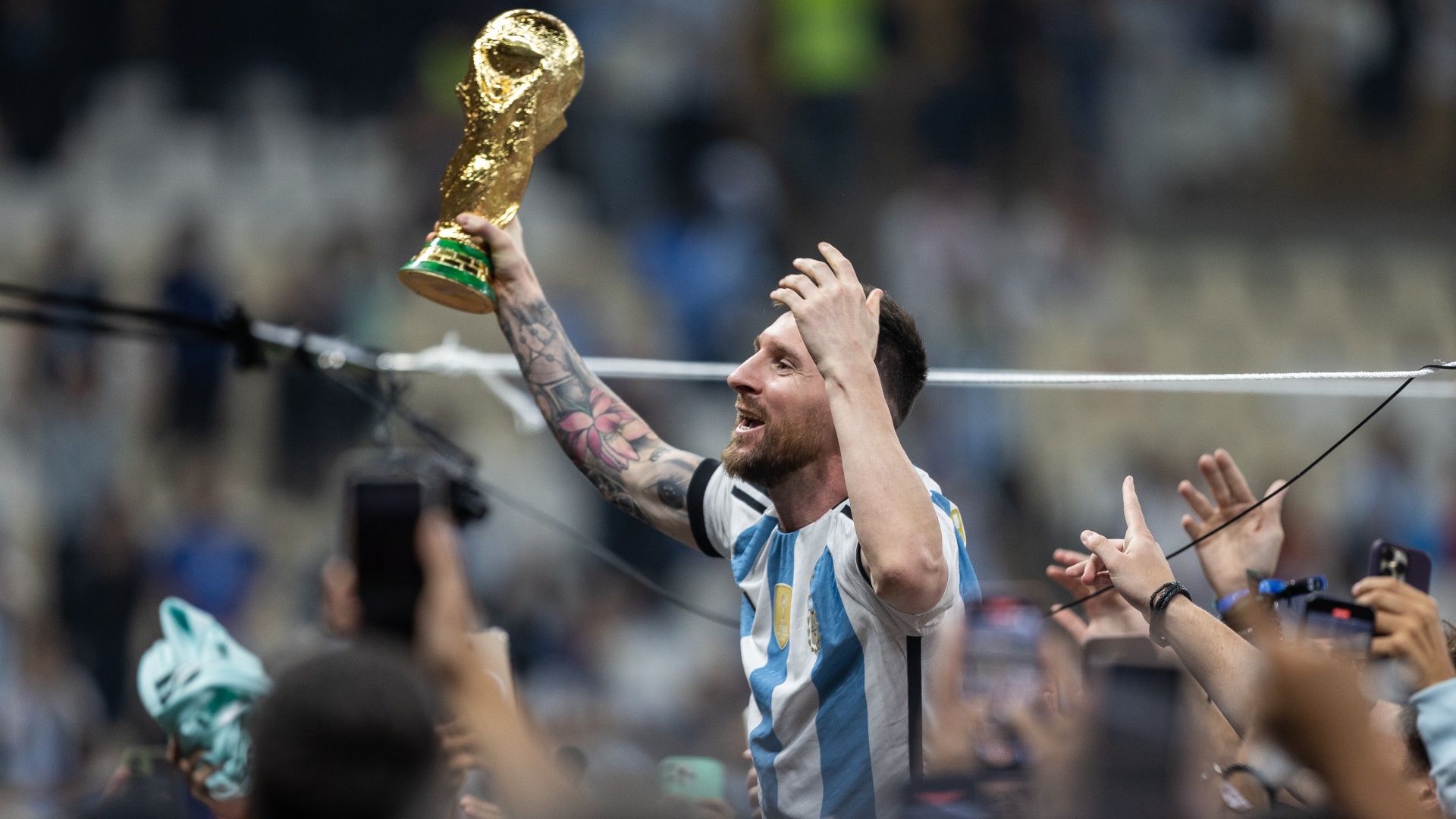 Argentina's Lionel Messi celebrating with the FIFA World Cup trophy in 2022