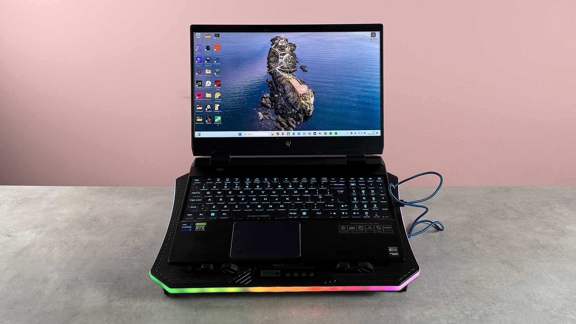 The TopMate C12 Laptop Cooling Pad showing RGB lighting, featuring the Acer Predator Helios 300.