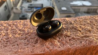 Atlantic Technology TWS1 earbuds on red surface