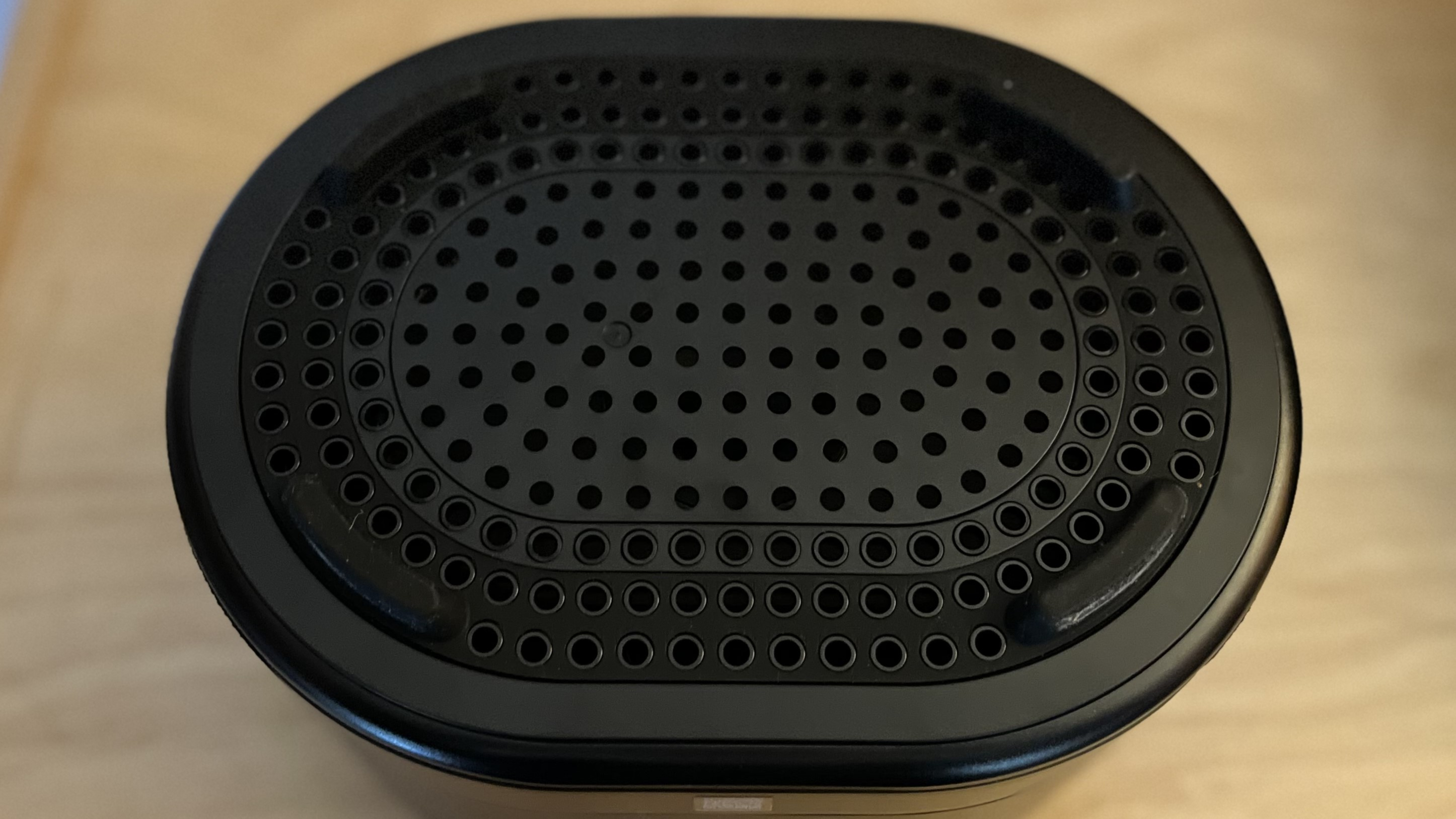 Brane X smart speaker on table showing bottom moiunted woofer
