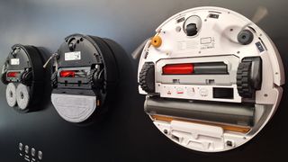 Roborock Saros 20, 20 Sonic and Qrevo Curv 2 robot vacuums flipped over to show mop system beneath