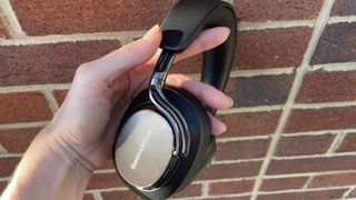Bowers & Wilkins Px8 S2 in front of a red brick wall