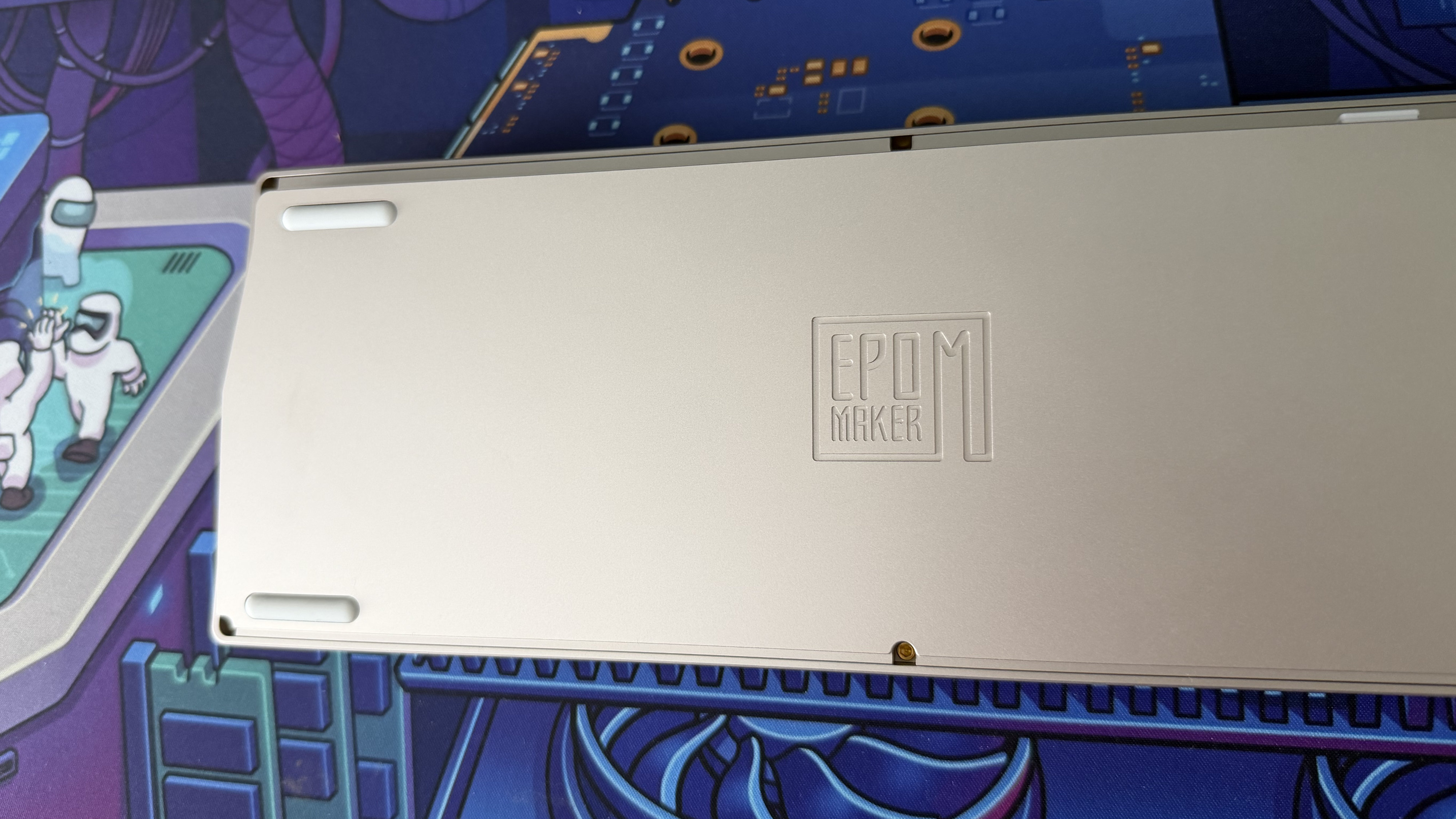 The underside of the Epomaker 65, showing its feet and logo.