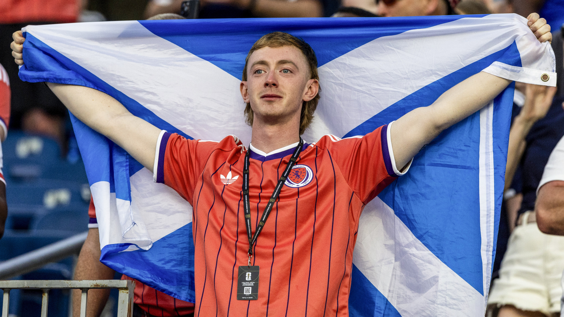 A Scotland fan stands in front of his country's flag at the FIFA World Cup 2026