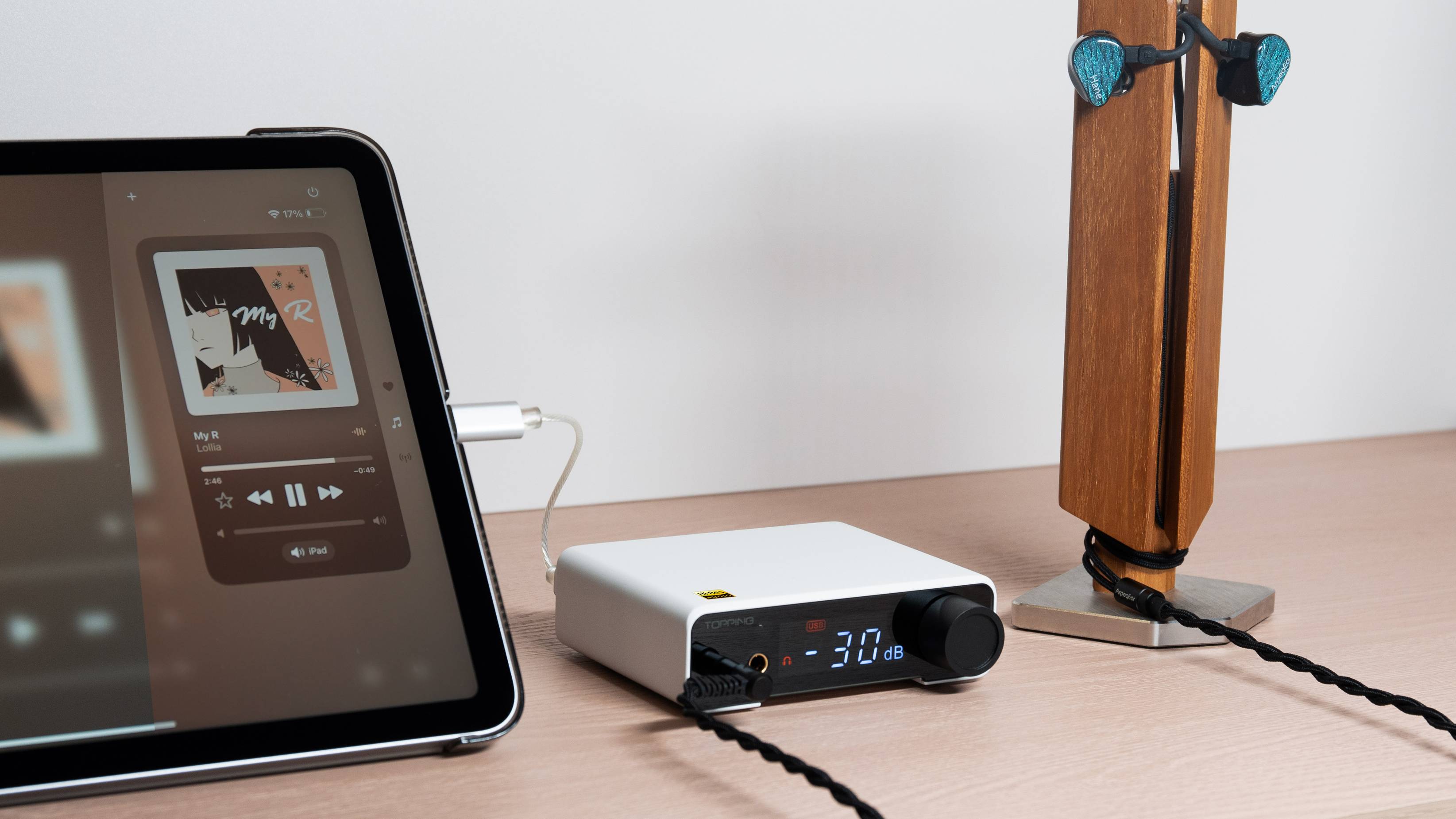 The Topping DX1 II plugged into a tablet and some earbuds.