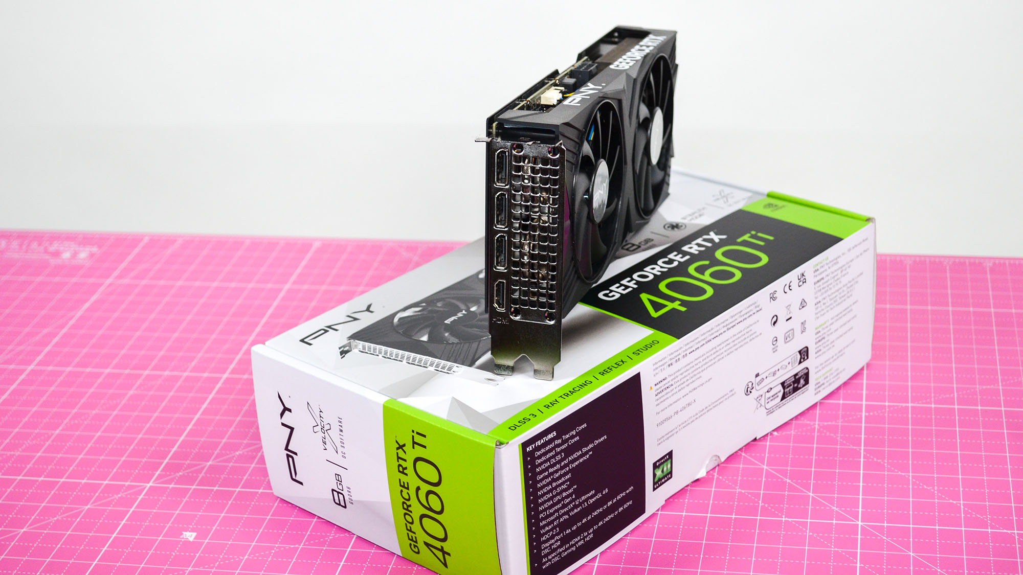A PNY GeForce RTX 4060 Ti on a desk with a pink desk mat.