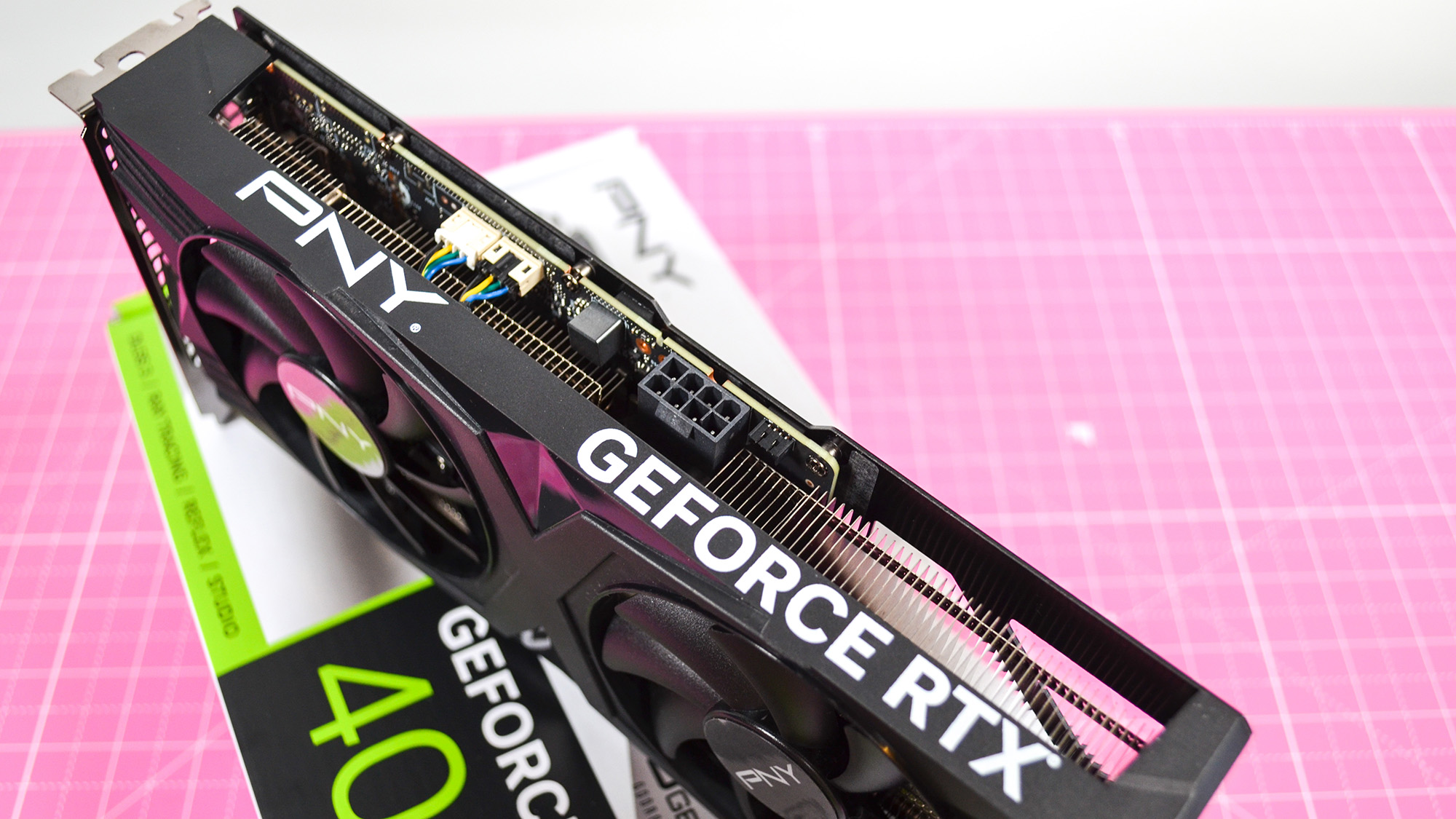 A PNY GeForce RTX 4060 Ti on a desk with a pink desk mat.