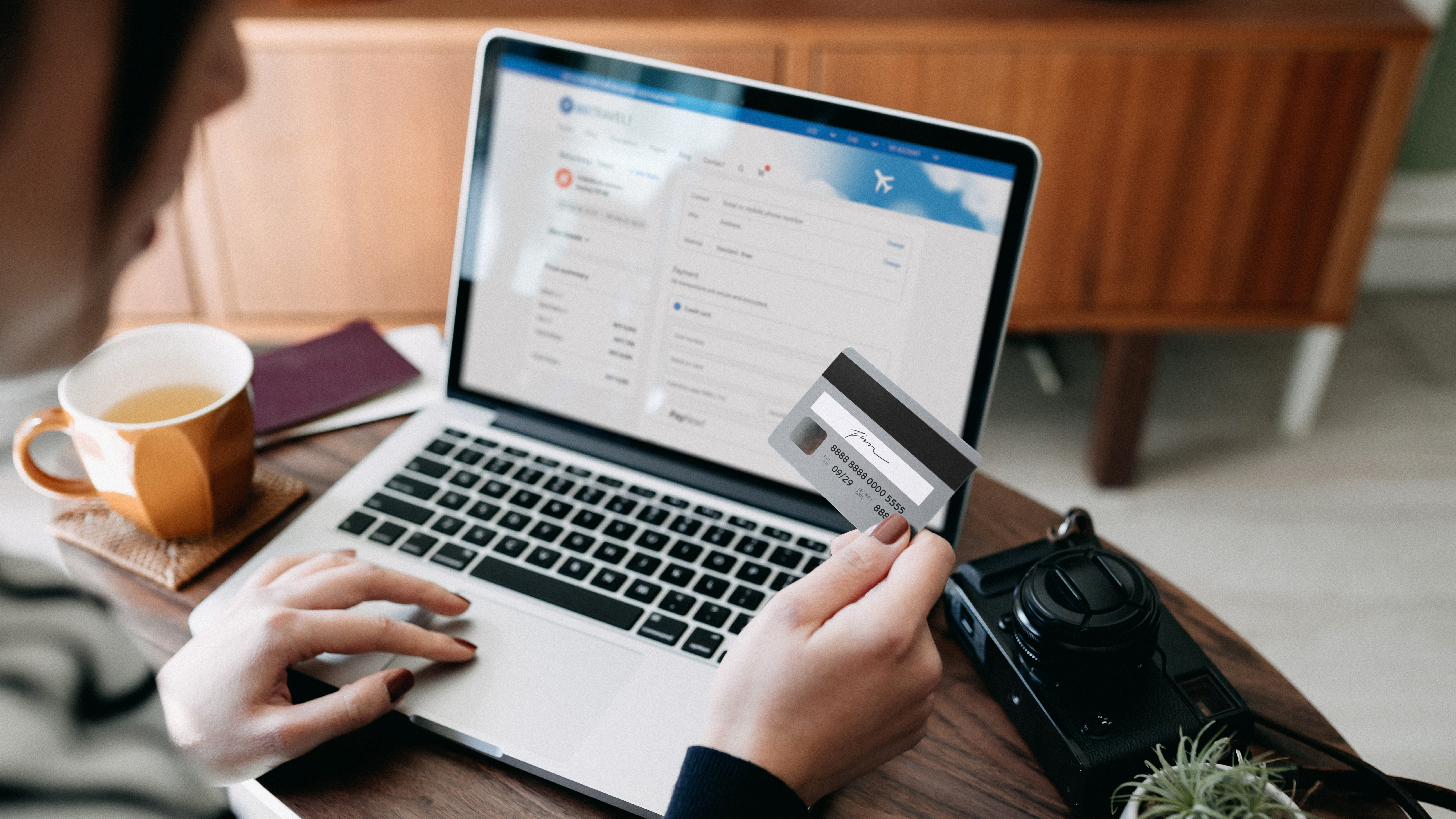 A person using their credit card to check out on their laptop.