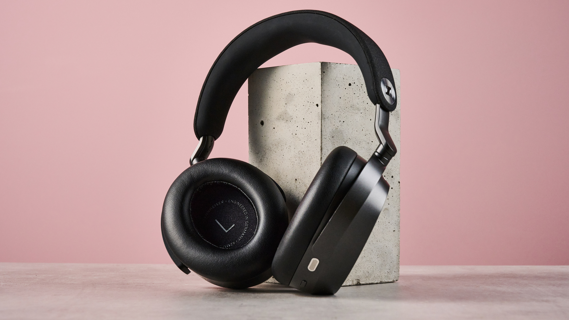 The Sennheiser Momentum 5 leaning against a concrete block.