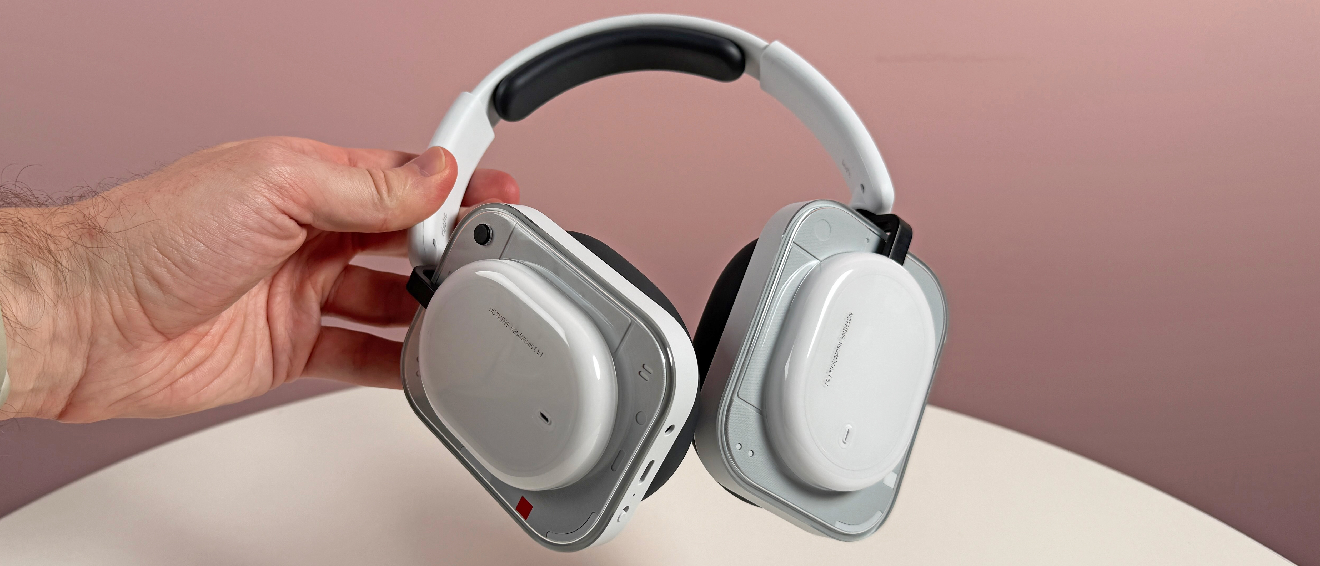 The Nothing Headphone (a) held in a man's hand