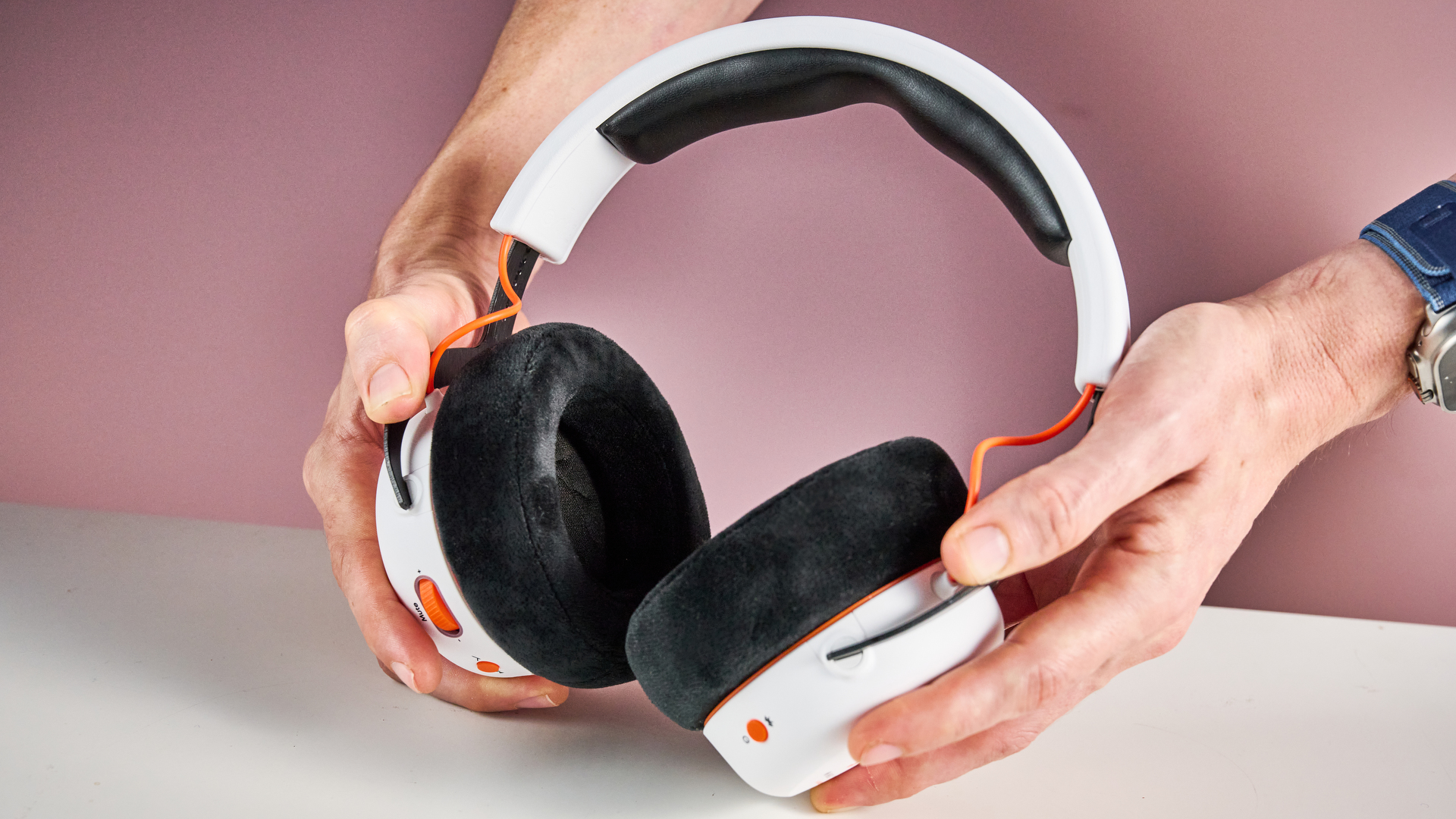 The Beyerdynamic MMX 150 Wireless held in a man's hands, showing the inside of the cups.
