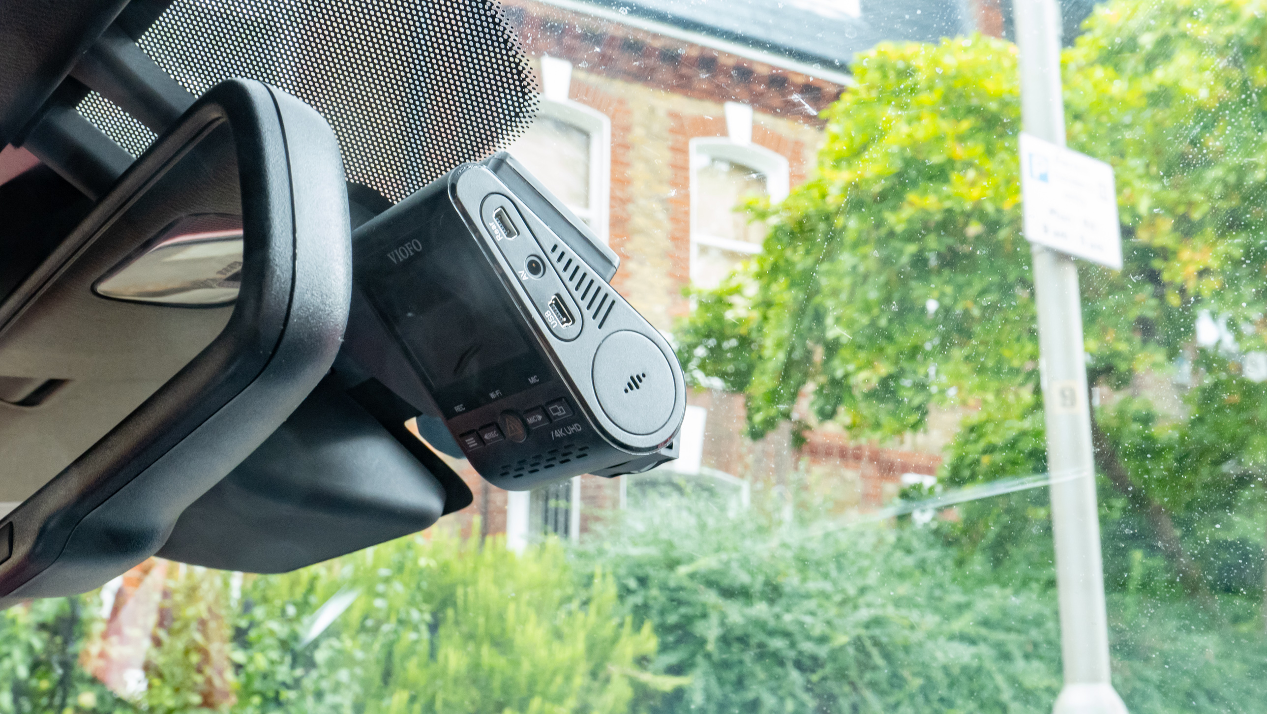 The Viofo A129 Pro Duo placed inside a car with urban background