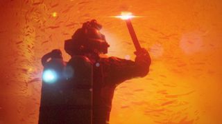 Character holding a flare underwater