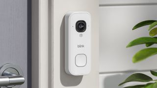 Blink Wired Video Doorbell 2K+ mounted on wall beside door