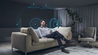 The Sony SRS-NS7 around a man's neck in the living room.