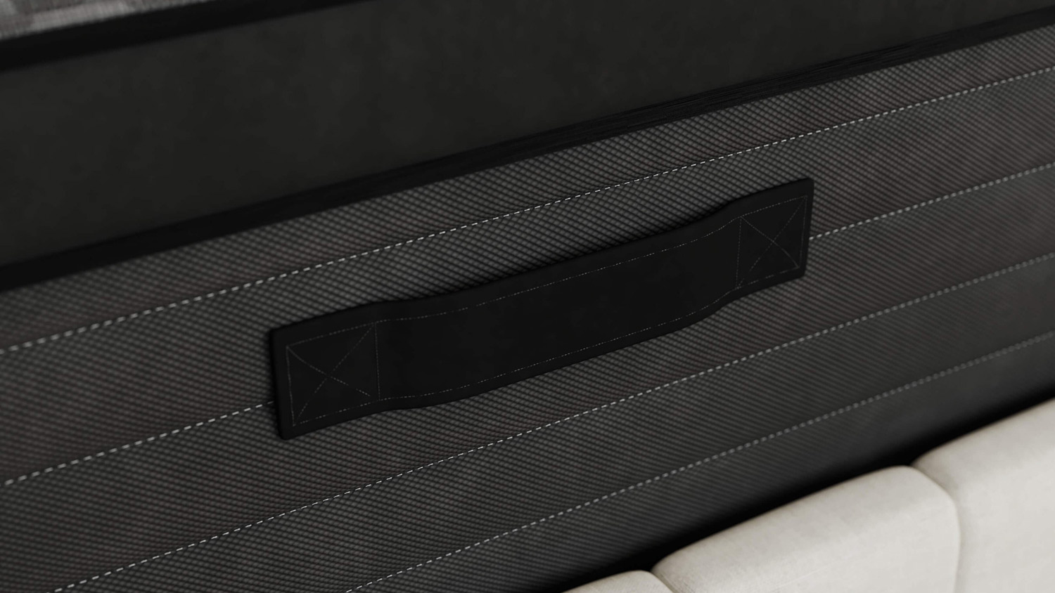 The edge of the Zoma Boost mattress, showing a handle