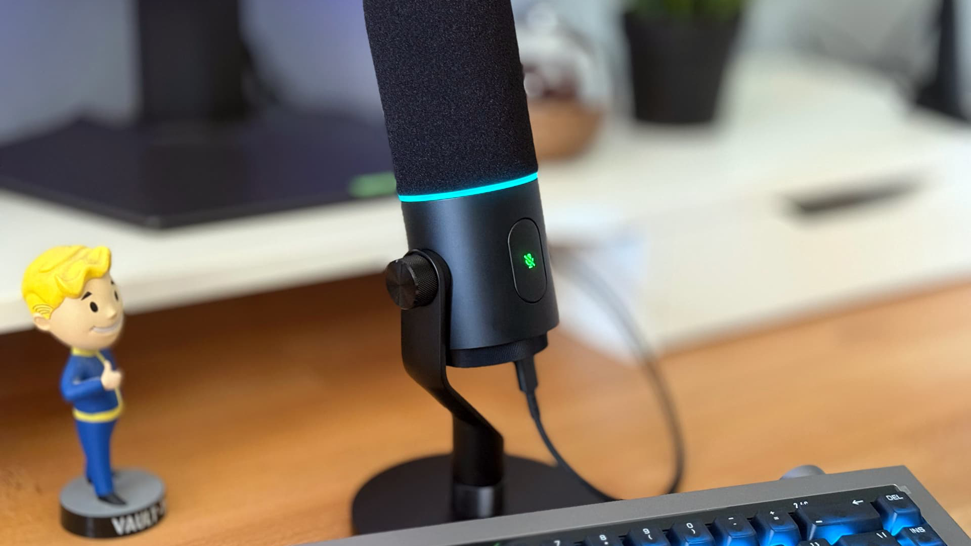 Razer Seiren V3 Pro microphone on wooden desk