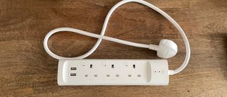 TP-Link Kasa Smart Wi-Fi Powerstrip KP303 on a wooden table