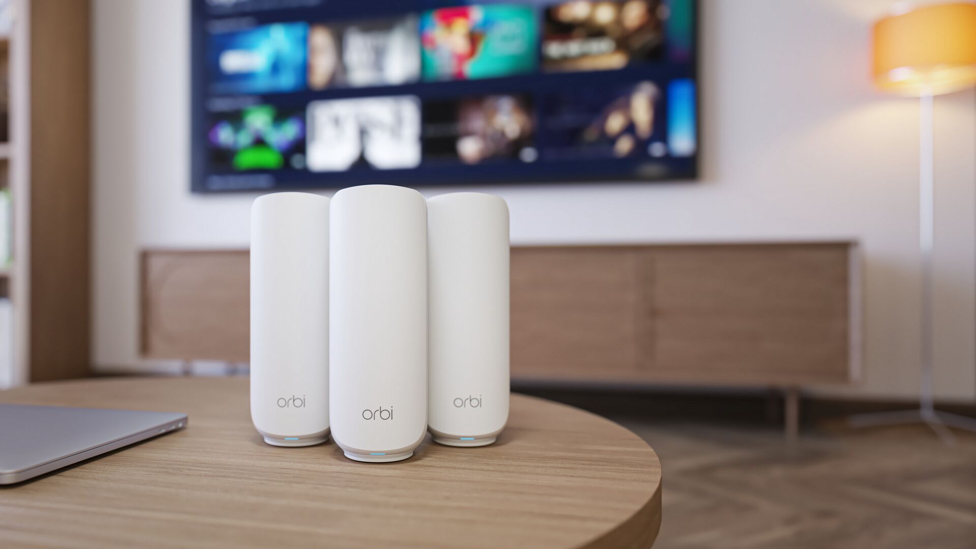 Netgear Orbi 373 with one router and two satellites on a wooden table