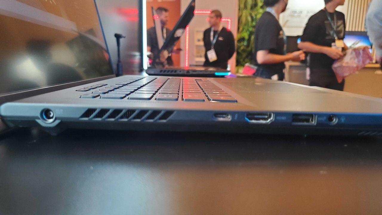 side view of black gaming laptop with lit keyboard
