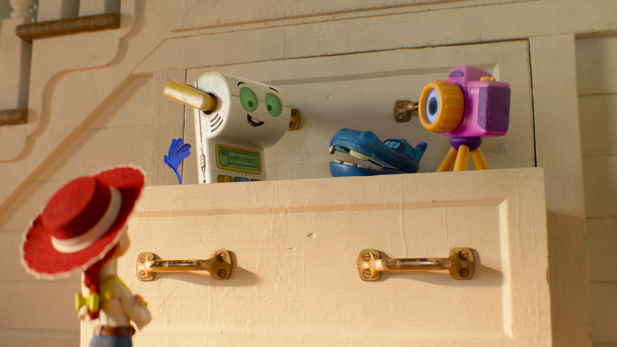 Jessie looking at Smarty Pants, Atlas, and Snappy standing in a drawer in Toy Story 5