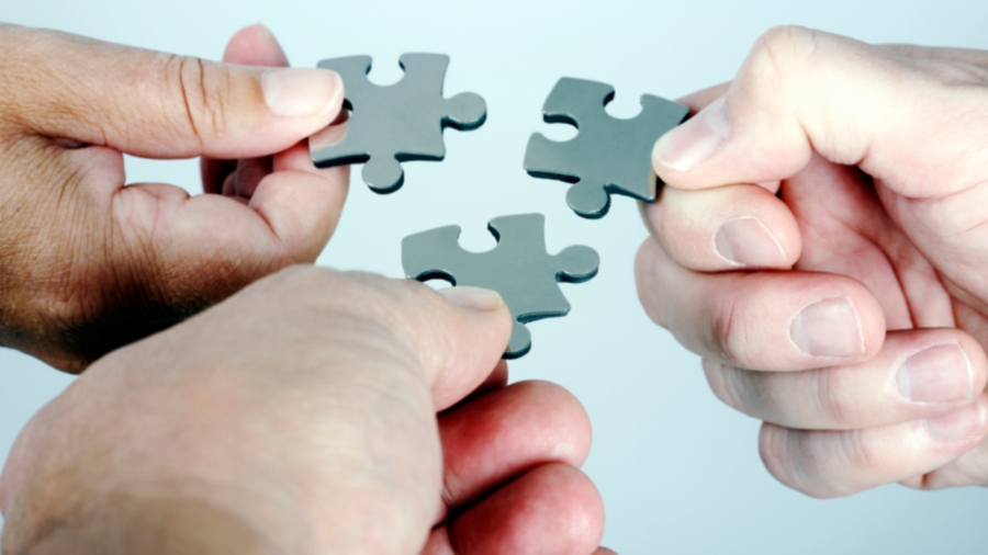 Fingers with jigsaw pieces