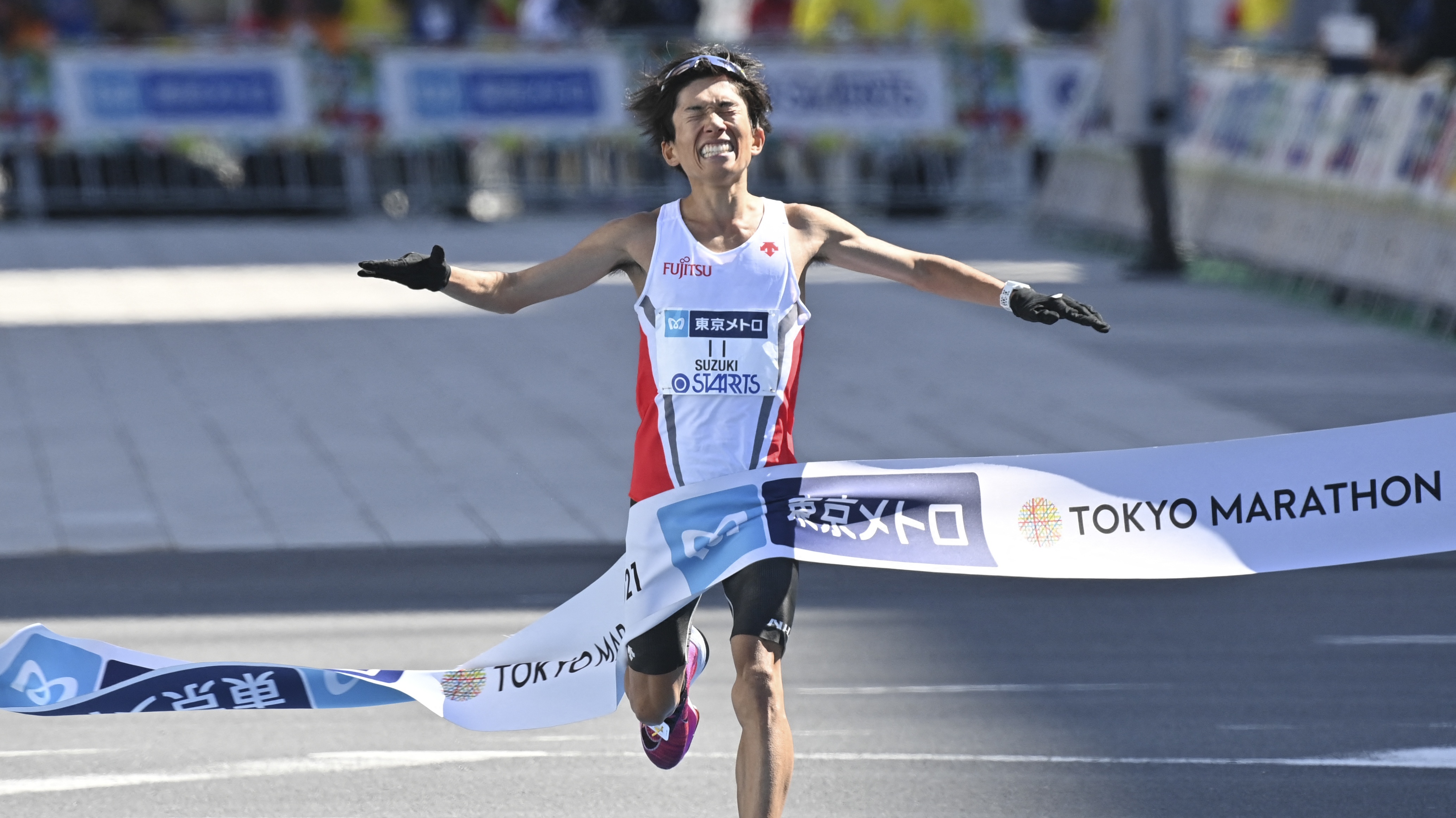 Japan's Kengo Suzuki crosses the finish line in the men's category of the Tokyo Marathon in Tokyo 