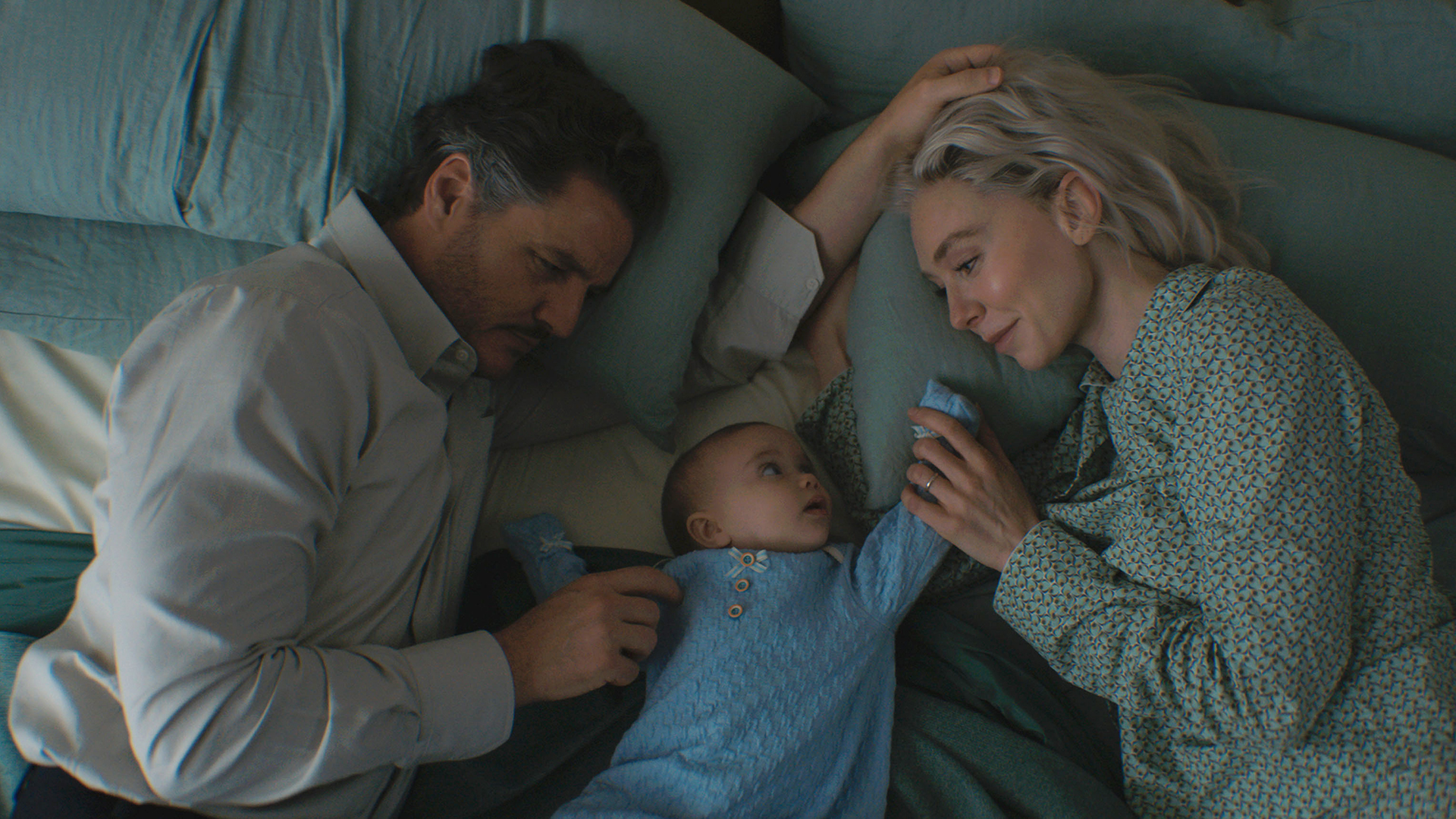 Reed Richards and Sue Storm looking at their baby boy Franklin in The Fantastic Four: First Steps