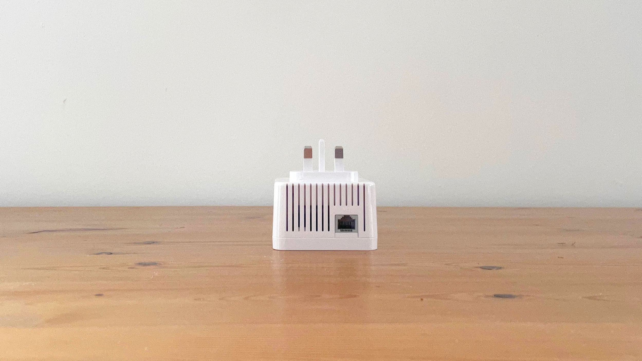 Devolo WiFi 6 Repeater 3000 on a wooden desk