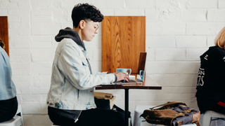 Person using laptop in cafe