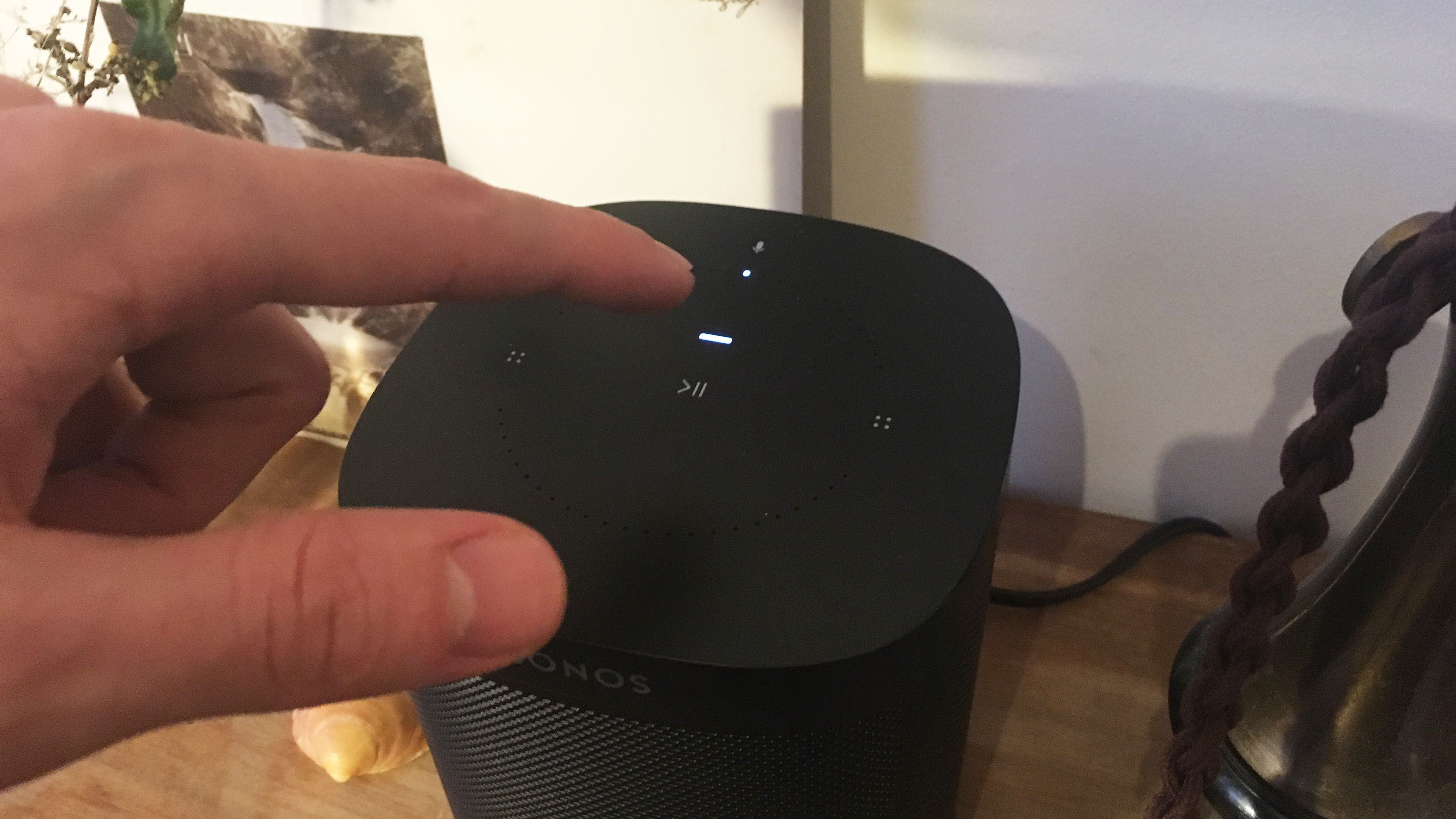 A close up of the controls on the top of the Sonos One smart speaker in black