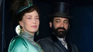 Bertha and George look out of a carriage window