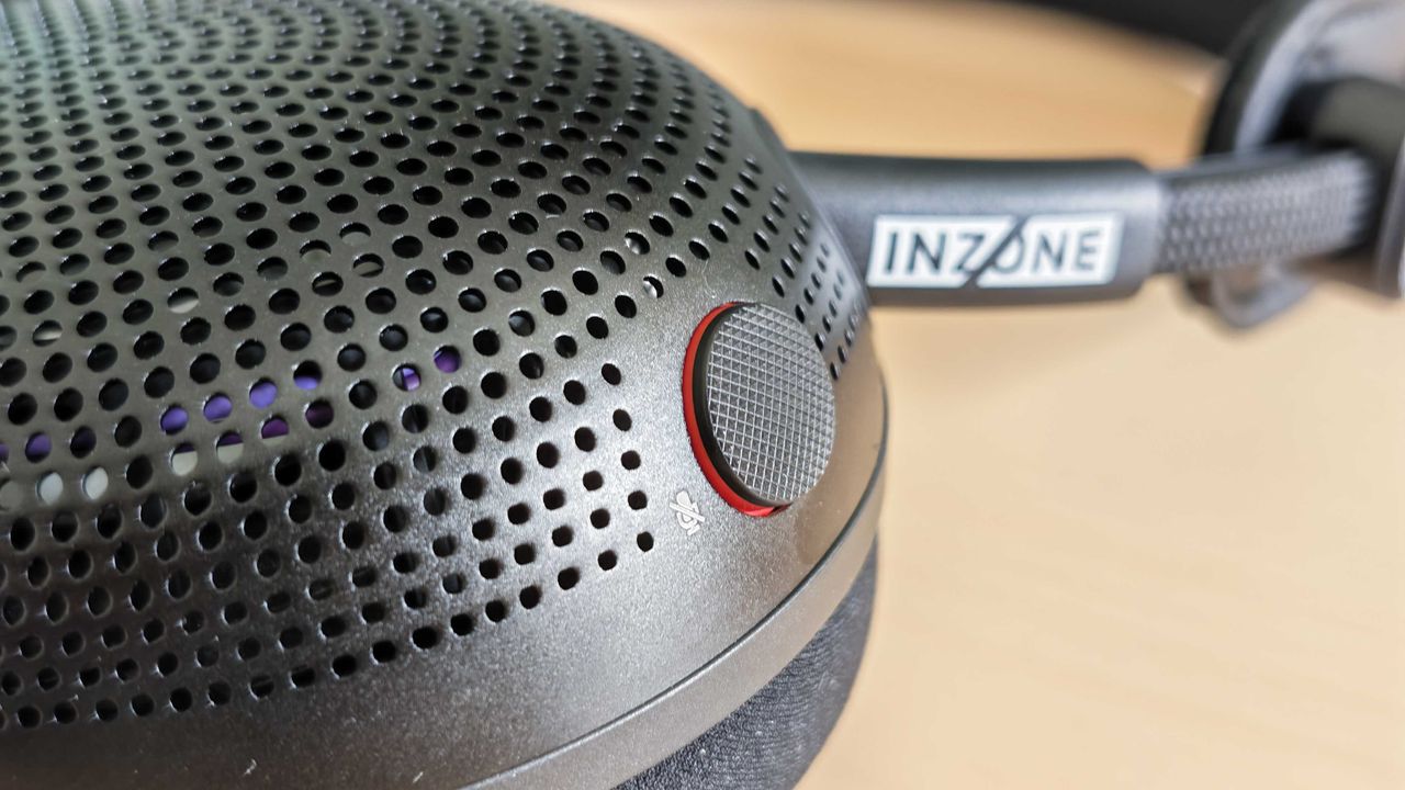 A photo of the Inzone H6 Air gaming headset positioned above a wooden desktop surface.