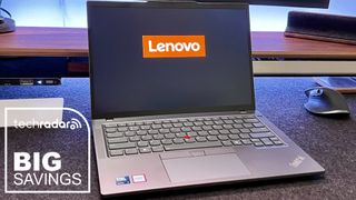 The Lenovo ThinkPad T14 on a home office desk during our review, with a white TechRadar badge in the lower left corner that reads 'Big Savings'