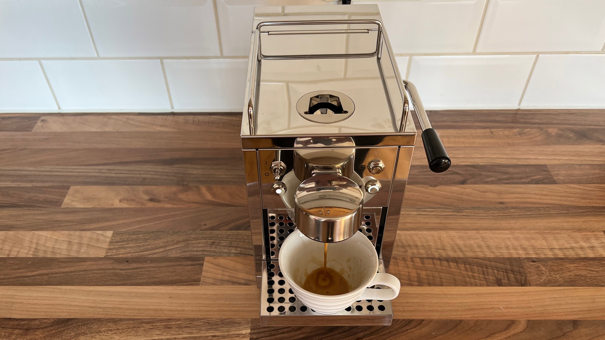 The Grind One Pod machine being used to brew an espresso