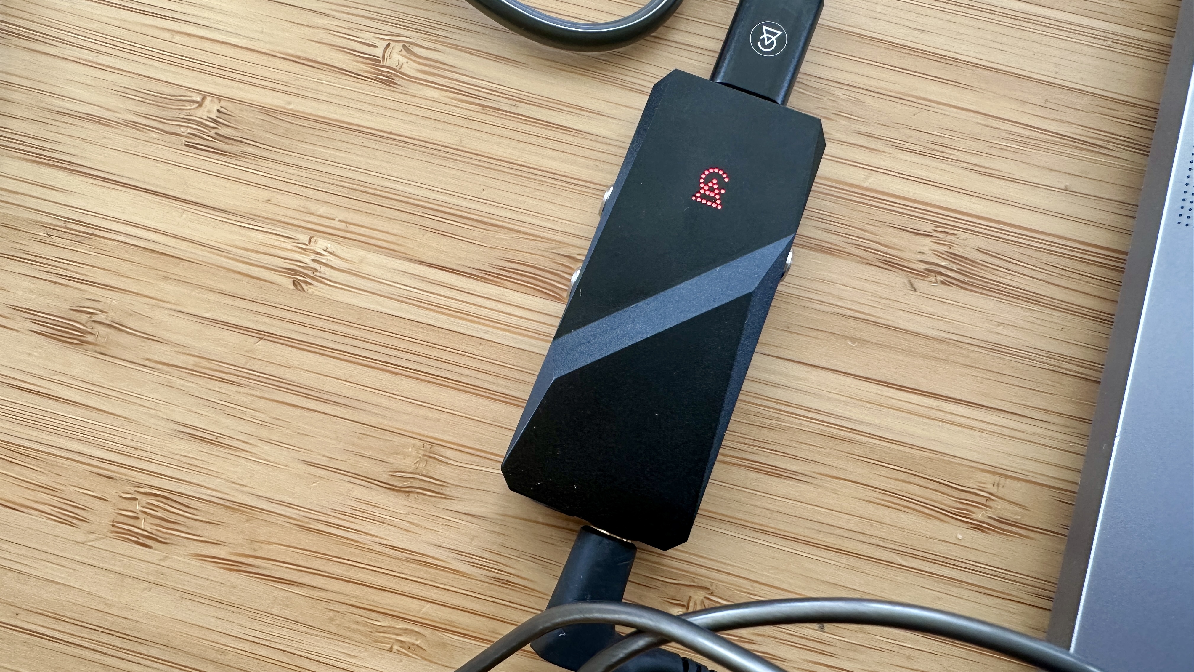 Campfire Audio Relay headphone DAC on a wooden surface