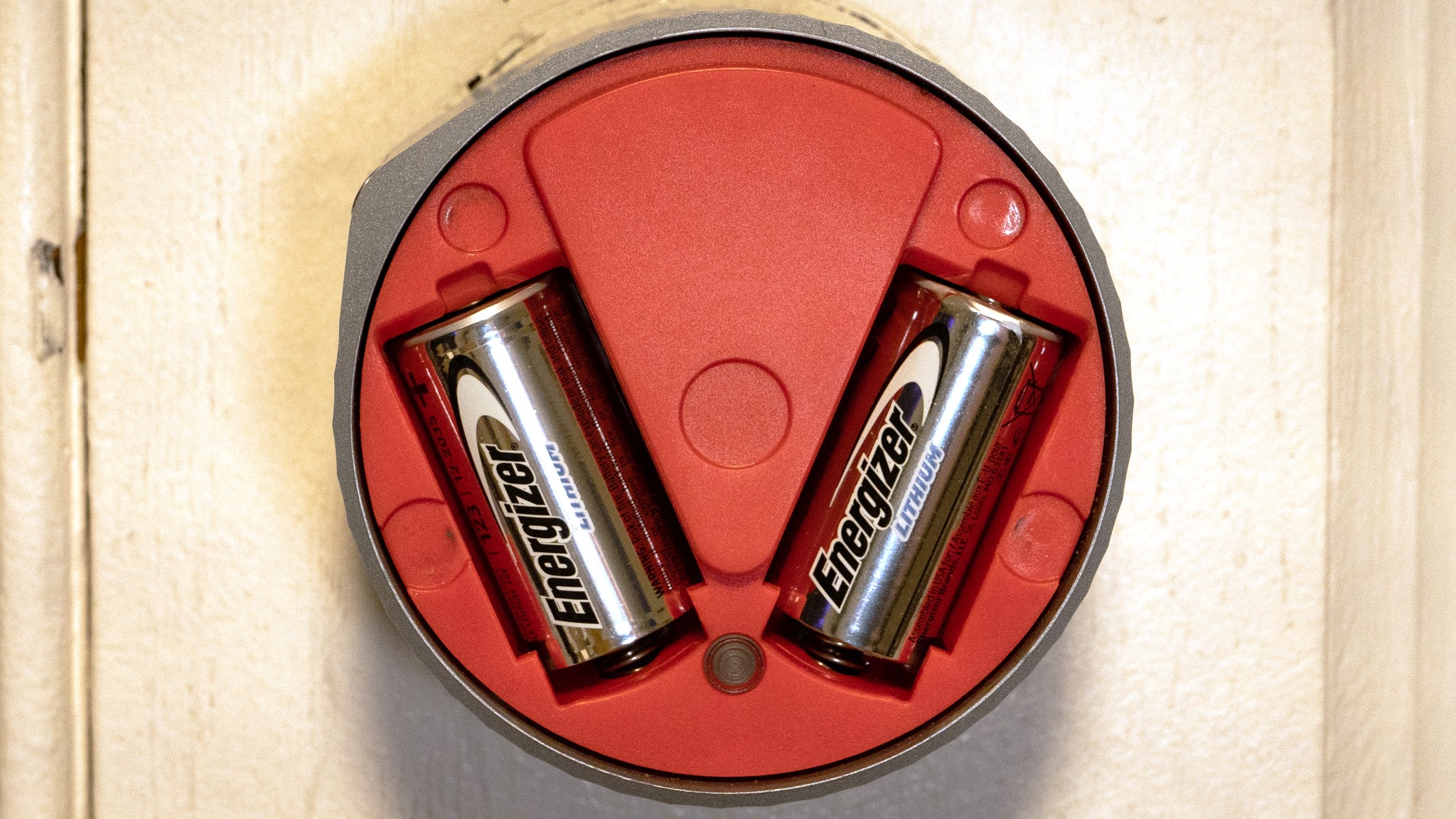 Smart lock on door with cover removed and two batteries installed