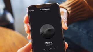 A hand holding a phone showing the ChatGPT voice mode feature