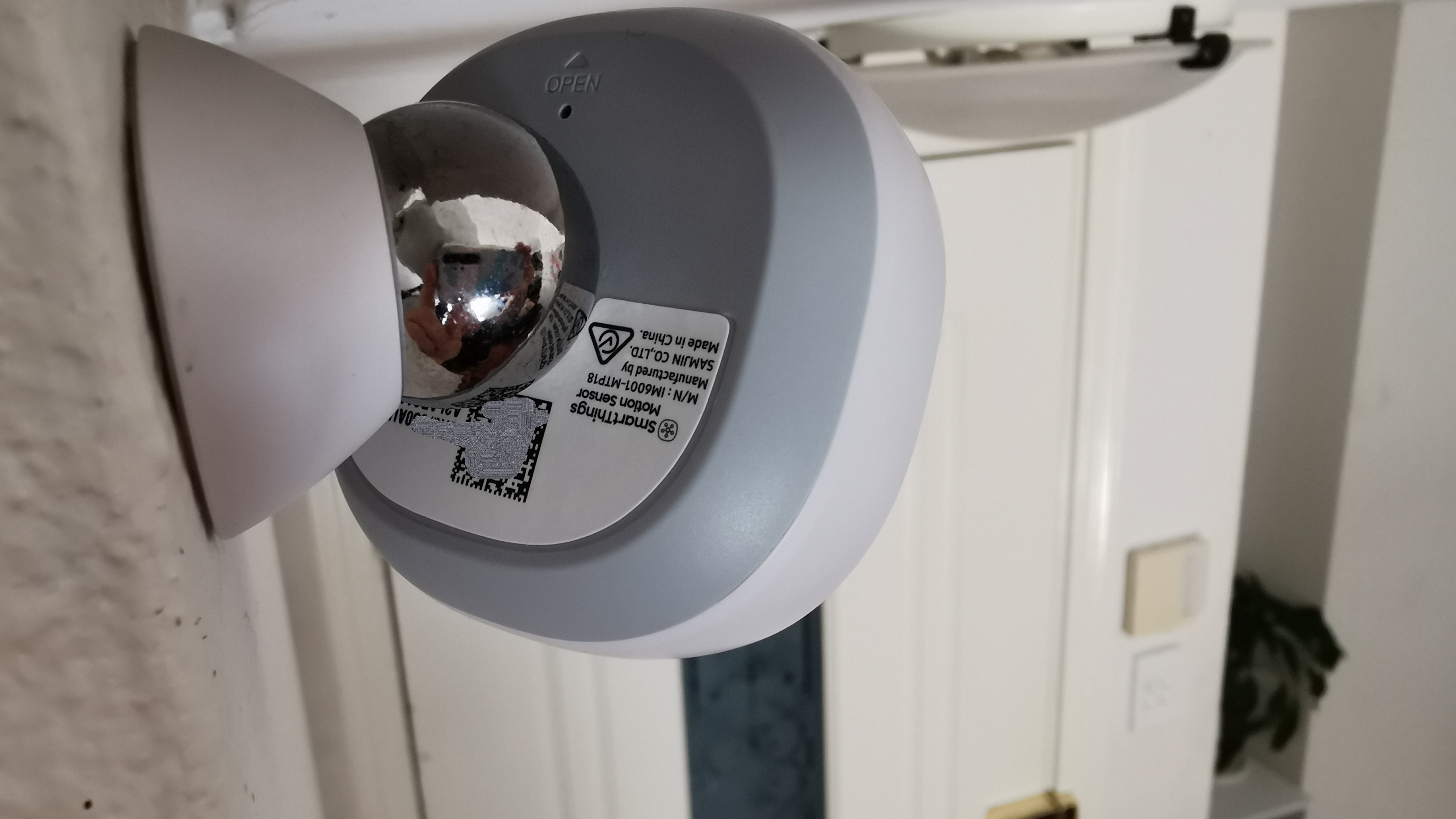 The Motion Sensors are attached to the wall via double-sided 3M sticky pads.